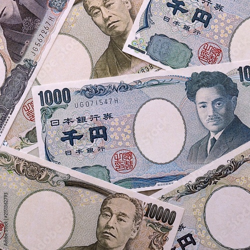 Japanese yen money bills pile on table. Japan banknotes of JPY currency close up.