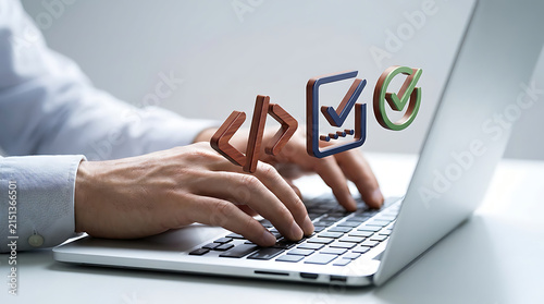 Software developer typing code on laptop with digital checkmark and programming icons