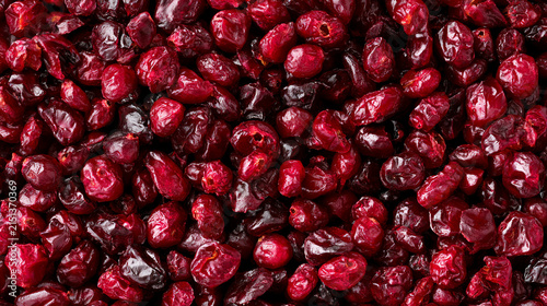 Closeup of dried cranberries background top view of a pile of red dried berries healthy food ingredient, organic snack, vegan food