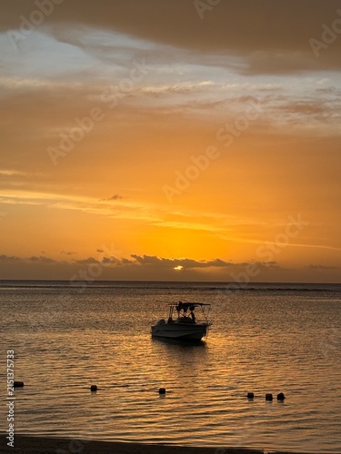  Golden sunset over the sea: motorboat and buoy line — horizontal