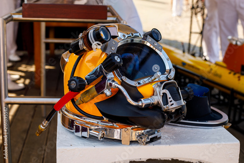 Fotografie Vintage diving helmet with metal fittings and glass visor on display outdoors, s