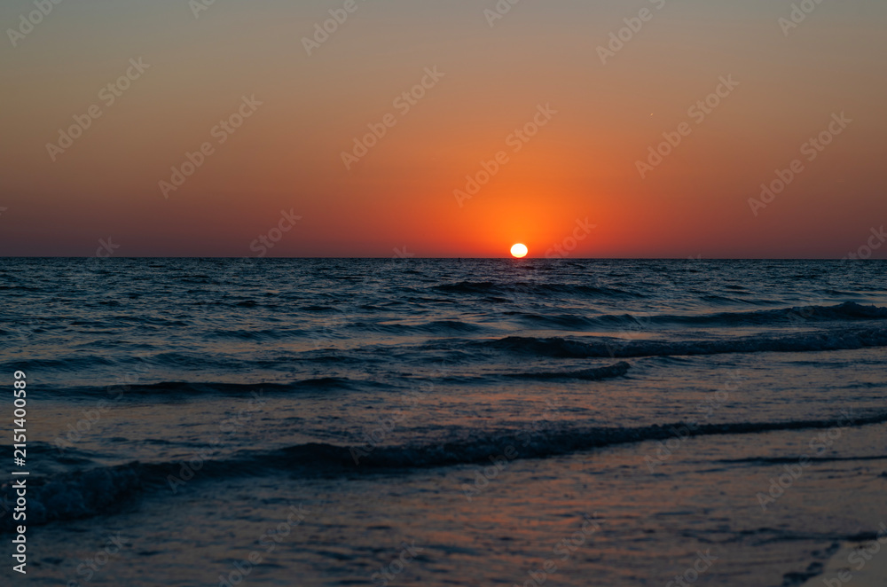 Fototapeta premium Sea sunset horizon. Sunset cloudy sky. Seascape at summer vacation. Caribbean sea. Skyscape with sea horizon. Horizon sunrise sea with waves. Sunrise seascape. Romantic summer vacation seascape