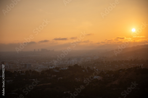 Sunset over the city skyline in California with view of the hills and clouds