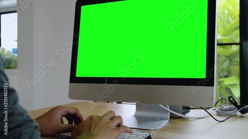 Desktop Computer with Green Screen and Person Typing