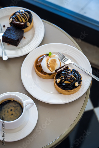 Dessert pastries and espresso coffee on table, top view