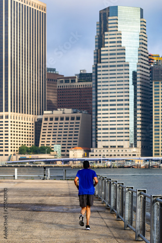 Photography Male Jogger Running along Brooklyn Bridge Park Waterfront Promenade with Lower M