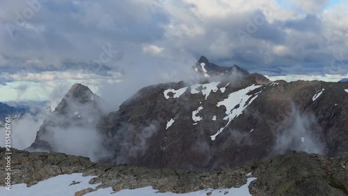 Majestic Mountain Peaks and Moving Clouds with Snow Patches in British Columbia, Canada