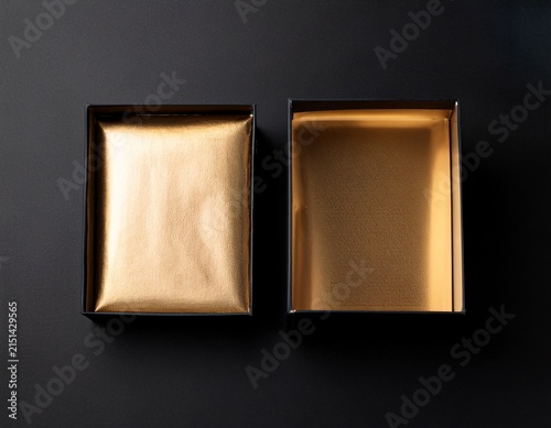 two black boxes mockup with golden wrapping paper opened and closed on black background