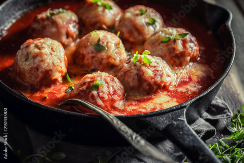 Spicy meatballs with cheese and tomato sauce.