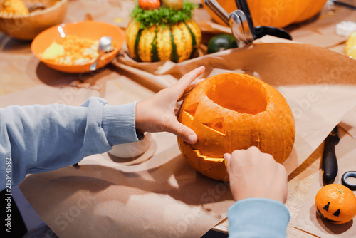 Konstfotografi Children Scooping Pumpkin During Halloween Carving Workshop