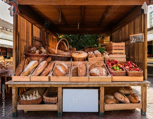 farmers market with artisanal bread and organic produce displayed with ample space for promotional text