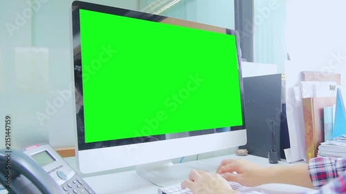 Desktop Computer with Green Screen in Modern Office Workspace