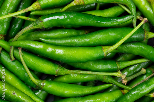Pile of fresh green Thai Jinda chili peppers.