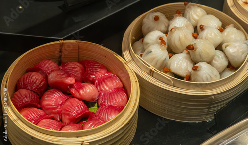 Fresh, handmade steamed dumplings on display ready for sale.
