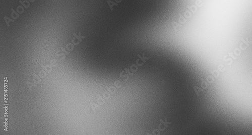 Фотография Abstract monochrome grey grain texture with bright light spot gradient background for professional photography backdrop and modern artistic design usage