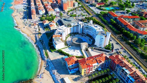 PORTO RECANATI, ITALY - JULY 30, 2025: Aerial top-down bird's-eye pullback shot of the beach. Porto Recanati's seaside amenities offer something for everyone, complete with Adriatic Sea lush waters
