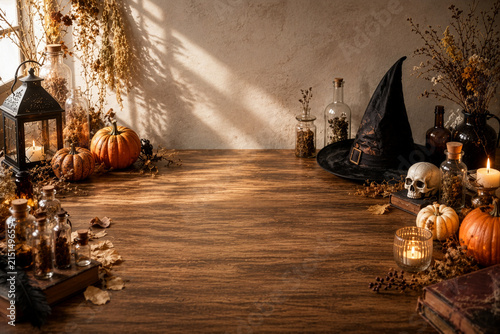Witch themed wooden table with hat, skull and potion bottles, mystical halloween product background
