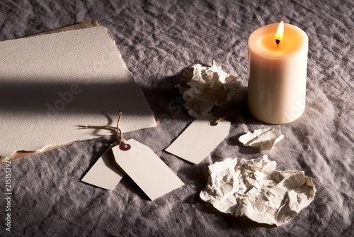 Editorial still life of soft linen surface for winter paper goods and torn paper textures.