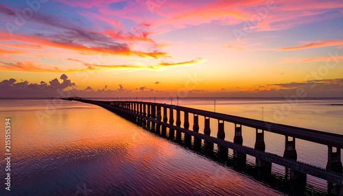 Dramatic sunset over bridge silhouette and ocean, Florida Keys aerial view with colorful sky