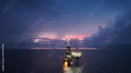 Aerial view of offshore jack up rig and offshore platform during sunset for oil and gas exploration and production. 
