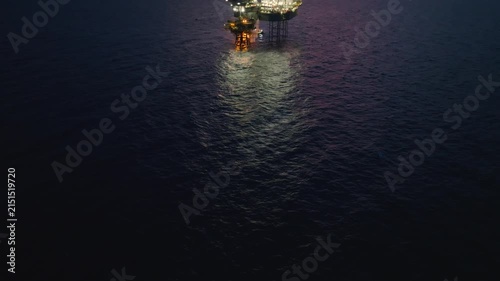 Aerial view of offshore jack up rig and offshore platform during sunset for oil and gas exploration and production. 