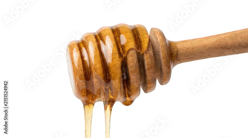 Wooden honey dipper with golden organic honey dripping isolated on white background