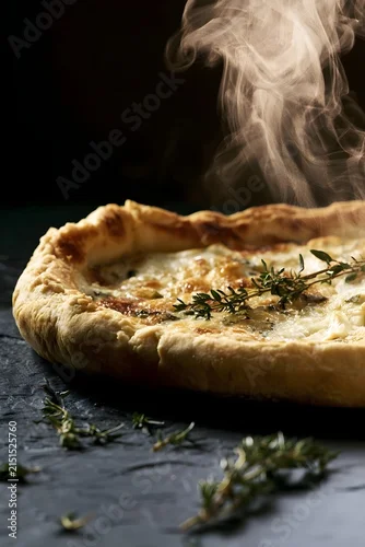 Fototapeta samoprzylepna Whole Goat Cheese Tart Low-Angle View with Curling Steam and Thyme