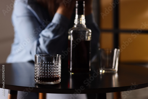 Fotografie Alcohol addiction and substance abuse with a person in distress and a glass of w