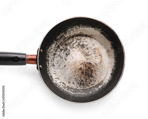 Fotografie Old worn frying pan with scratched non-stick coating and rusty handle, kitchen u