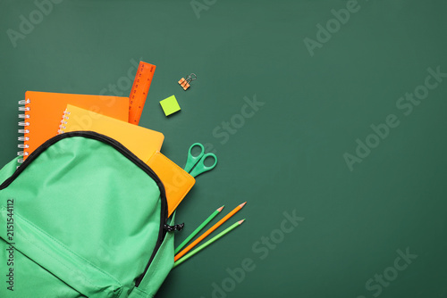 Green backpack with school ...