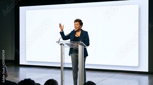 Professional African American woman giving a business presentation on stage