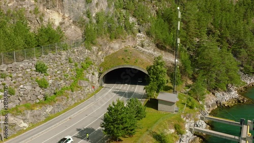 Aerial drone footage of the entrance to Amlatunnelen near Mannheller in Sogndal, Norway. The road tunnel on National Road 5 leads directly toward the Mannheller–Fodnes ferry connection 