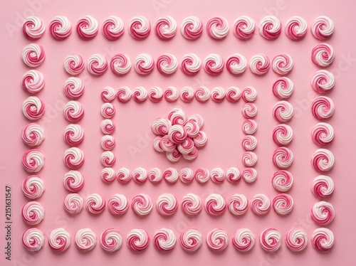 A Perfectly Symmetrical Arrangement of Pink and White Swirled Meringue Cookie Treats