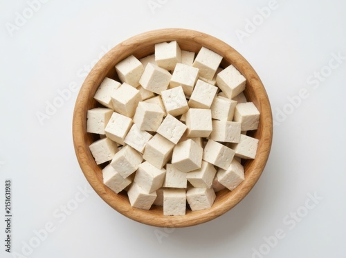 A Top Down View Of Cubed Tofu Inside A Simple Wooden Bowl