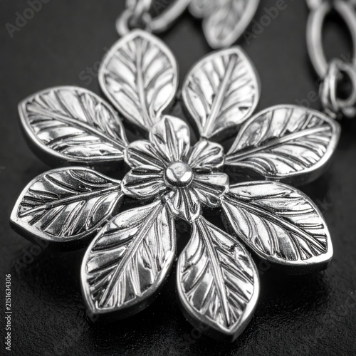Close-up of silver floral jewelry pendant.