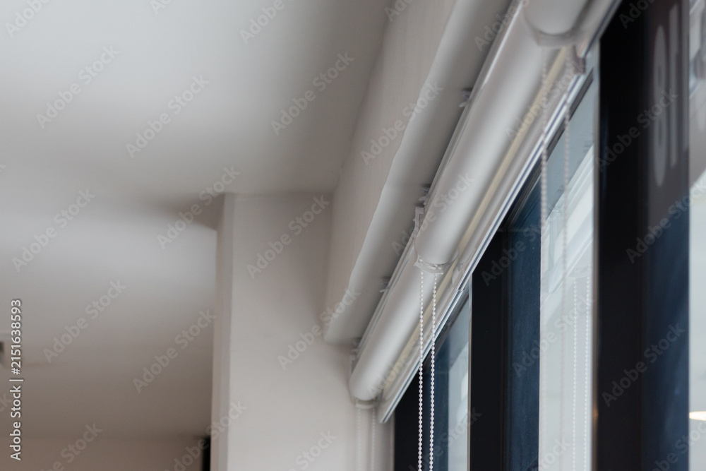 Obraz premium White roller blinds on large window
