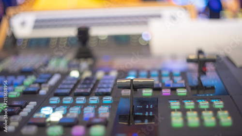 Video production switcher T-bar fader control panel with colorful buttons and copy space