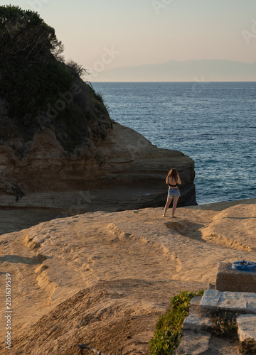Cuadro en lienzo young woman standing on sandstone cliffs admiring the mediterranean sea view dur