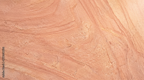 Coral pink sandstone texture background. Natural stone surface with organic wavy patterns.