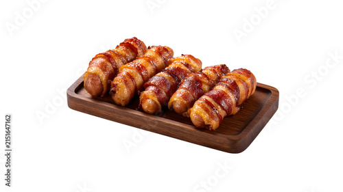 Pigs in blanket sausages wrapped in bacon on tray