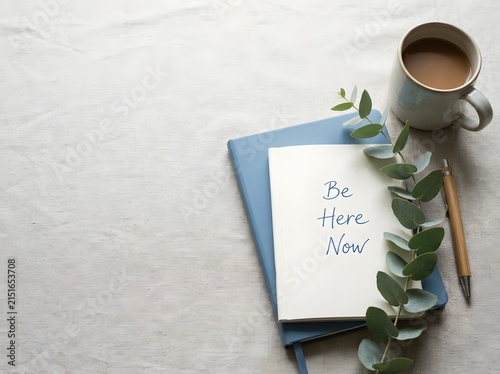 Flat lay of a blue notebook and open journal with the handwritten text 