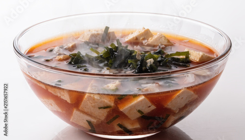 Tofu seaweed miso soup clear bowl hot steaming Japanese cuisine healthy vegetarian broth close up close up of hot miso soup with tofu and seaweed clear bowl showcasing steaming broth and fresh