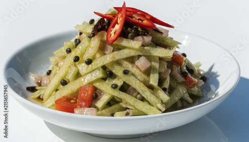 Green papaya salad spicy fresh chili black seed tomato diced vegetable Thai cuisine tangy appetizer close up