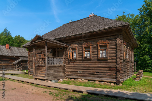 Log residential semi-detached house from Votrosa village in Pestovo District in the Novgorod Museum of Folk Wooden Architecture Vitoslavlitsy on a summer day, Veliky Novgorod, Russia