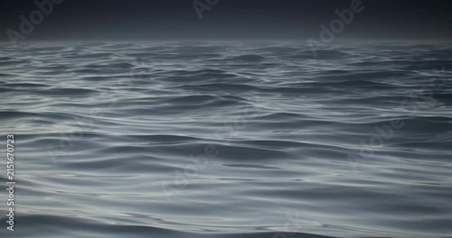 Dark ocean waves rolling rhythmically in this seamless loop animation showing the endless deep blue sea under a moody overcast sky in cinematic digital motion footage.