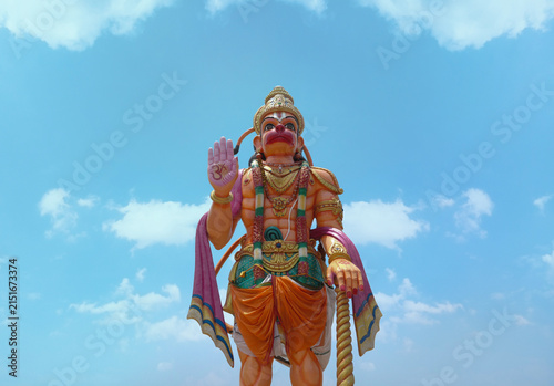 Fotografie Towering Lord Hanuman Statue with Blessing Gesture Under Blue Sky