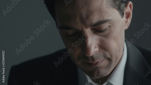 Emotional businessman reflecting on tough challenges and decisions