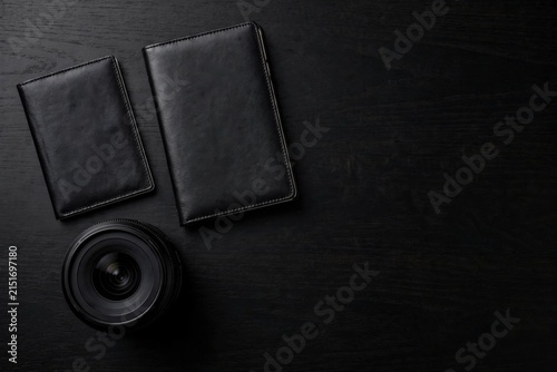 Minimalist Black Leather Wallets and Speaker on Dark Background.