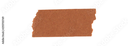 A piece of brown adhesive tape strip with a rough torn paper edge texture