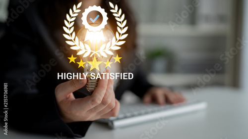 Canvastavla Business Professional Holding Light Bulb Symbolizing Innovation with Satisfaction Badge and Stars in the Background for Marketing and Branding